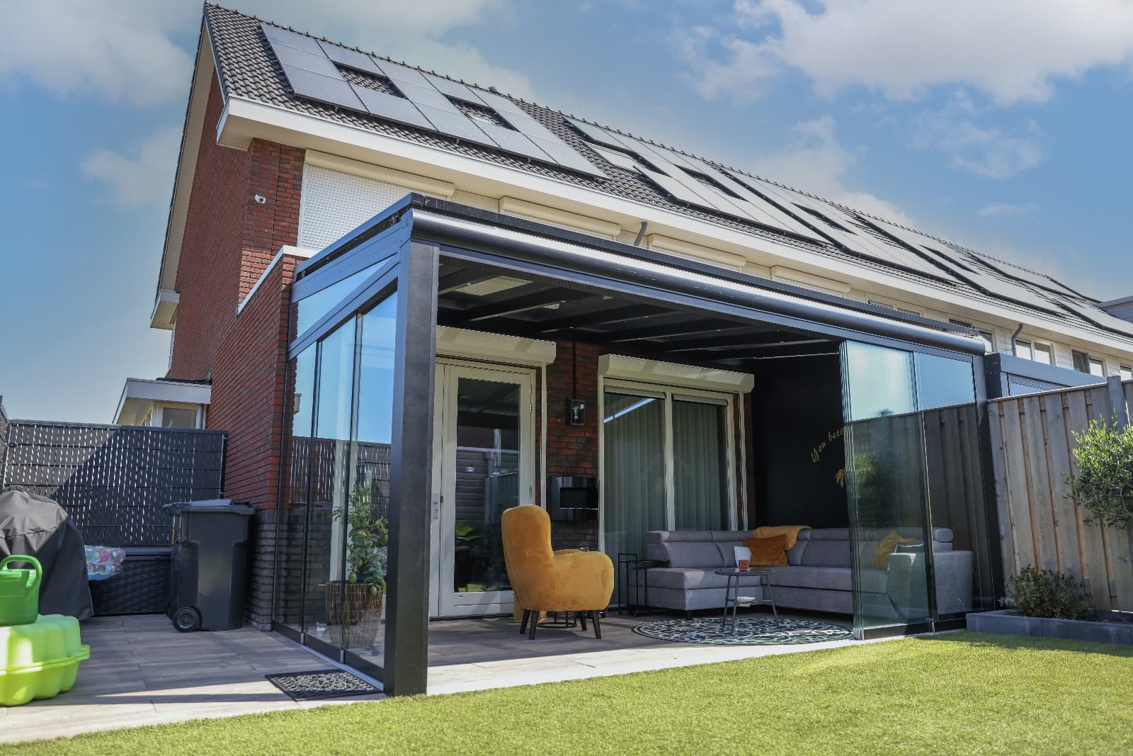 The Provence glass-roofed veranda with sliding wall and orange chair
